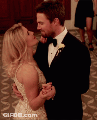 Man In Tuxedo And Woman In White Dress Dancing GIF