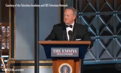 Man In Tuxedo At Emmys Podium GIF