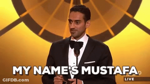 Man In Tuxedo At Microphone Says My Name's Mustafa Live GIF