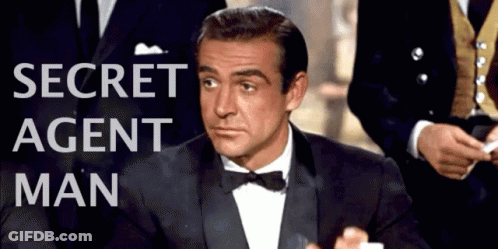 Man In Tuxedo At Secret Agent Man Sign GIF