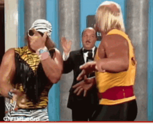 Man In Tuxedo Between Wrestlers GIF
