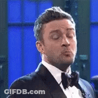 Man In Tuxedo Blowing Kiss Eyes Closed GIF