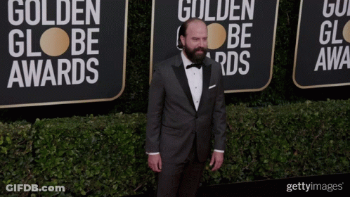 Man In Tuxedo By Golden Globe Awards Wall GIF