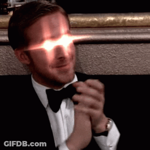 Man In Tuxedo Clapping Hands With Glowing Eyes GIF