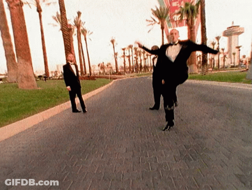 Man In Tuxedo Dancing On Brick Road GIF