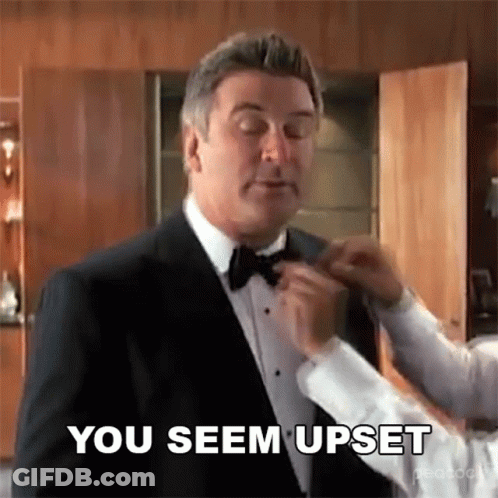 Man In Tuxedo Getting Bow Tie Adjusted By Man In White Shirt GIF