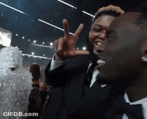 Man In Tuxedo Giving Peace Sign GIF