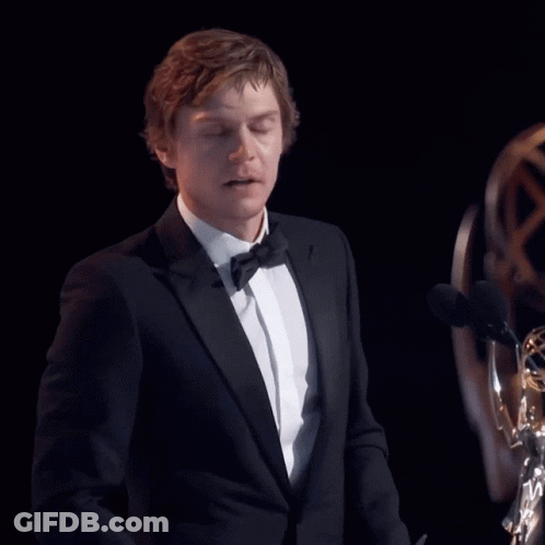 Man In Tuxedo Giving Speech At Two Microphones GIF