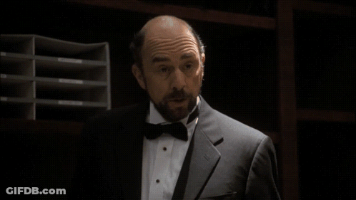 Man In Tuxedo Holding Born In Congress Pamphlet GIF