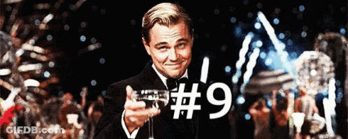 Man In Tuxedo Holding Champagne Glass With Number 9 GIF