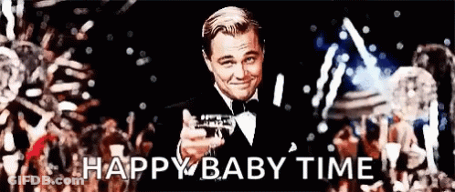 Man In Tuxedo Holding Champagne In Front Of Crowd GIF
