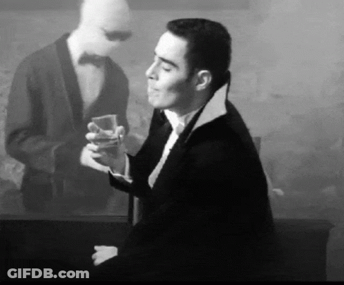 Man In Tuxedo Holding Drink GIF