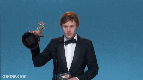 Man In Tuxedo Holding Emmy Trophy GIF