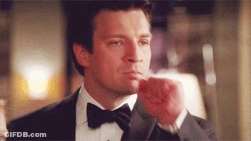 Man In Tuxedo Holding Fist Up GIF