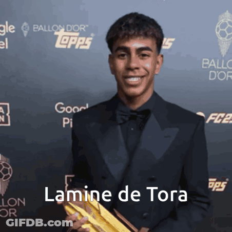 Man In Tuxedo Holding Gold Trophy Lamine De Tora GIF
