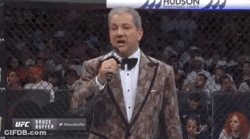 Man In Tuxedo Holding Microphone GIF