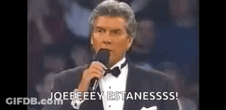 Man In Tuxedo Holding Microphone Saying Joeeeey Estanesss GIF
