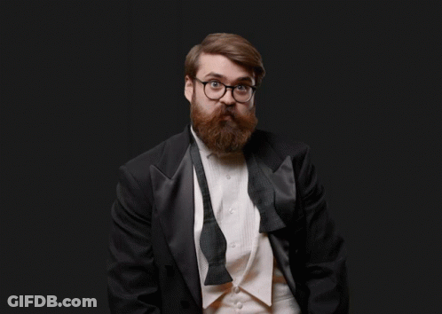 Man In Tuxedo Holding Orange Pumpkin GIF
