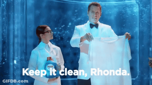 Man In Tuxedo Holding Shirt Next To Woman In Lab Coat GIF