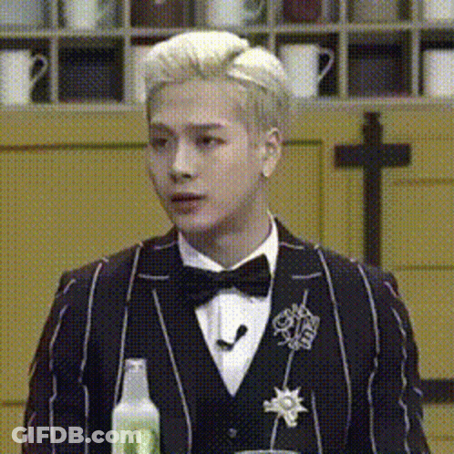 Man In Tuxedo Holding Soda Bottle GIF