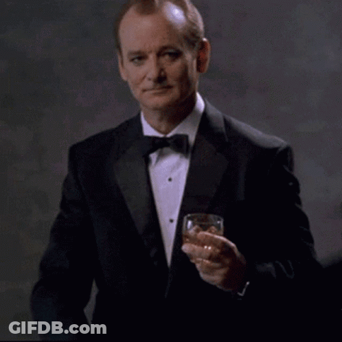 Man In Tuxedo Holding Whiskey Says Youre Welcome GIF