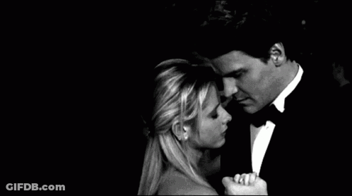 Man In Tuxedo Hugging Woman In Dress At Party GIF