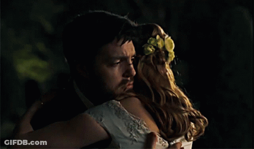 Man In Tuxedo Hugging Woman In White Dress GIF