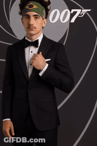 Man In Tuxedo In Front Of 007 Sign GIF