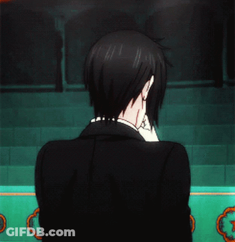 Man In Tuxedo In Front Of Green Wall GIF