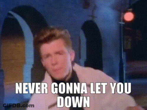 Man In Tuxedo In Front Of Never Gonna Let You Down Sign GIF