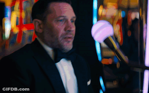Man In Tuxedo In Front Of Slot Machine With Word Ke GIF