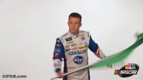 Man In Tuxedo In Front Of UI Sign GIF