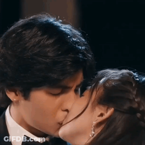 Man In Tuxedo Kissing Woman In Dress GIF