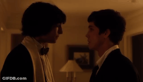 Man In Tuxedo Looking At Man In White Shirt GIF