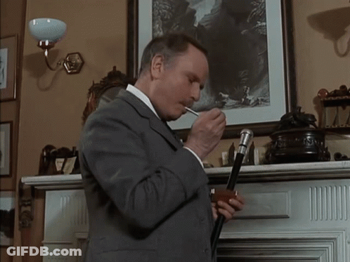 Man In Tuxedo Looks At Camera GIF
