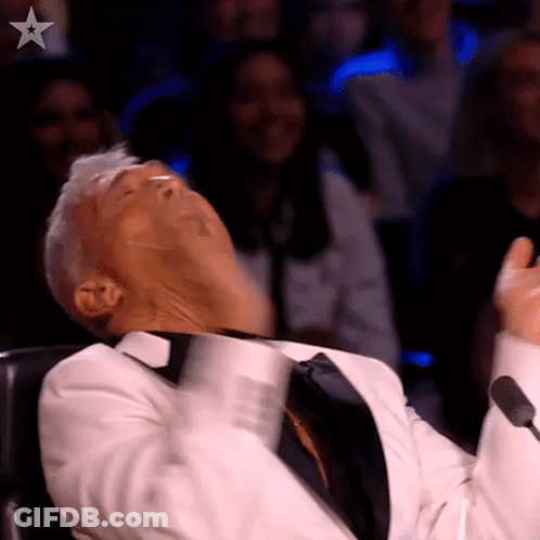 Man In Tuxedo Making Funny Face At Microphone GIF
