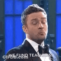 Man In Tuxedo Making Funny Face Saying We Fund Teachers GIF