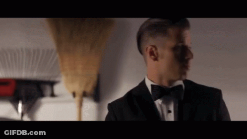 Man In Tuxedo Next To Broom GIF