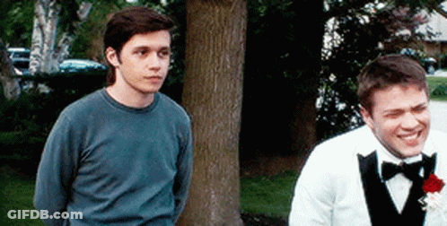 Man In Tuxedo Next To Man In Blue Shirt GIF