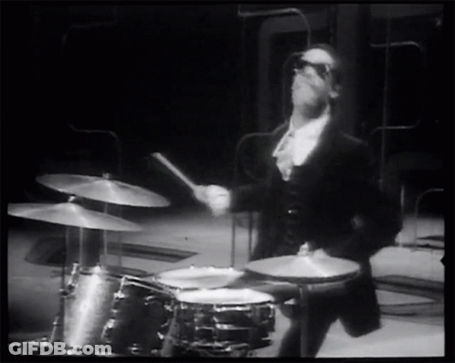 Man In Tuxedo Playing Drums GIF