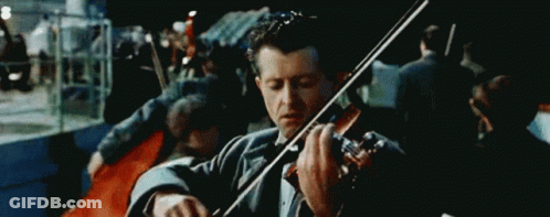 Man In Tuxedo Playing Violin In Front Of Crowd GIF