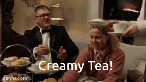 Man In Tuxedo Pouring Creamy Tea Into Woman GIF
