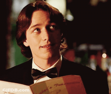 Man In Tuxedo Reading Mediterranean Menu GIF