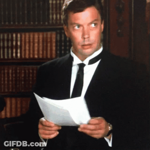 Man In Tuxedo Reading Paper GIF