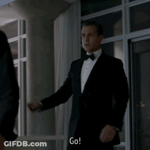 Man In Tuxedo Saying Go In Front Of Window GIF