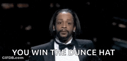 Man In Tuxedo Saying You Win The Dunce Hat GIF