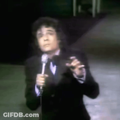 Man In Tuxedo Singing Into Microphone GIF