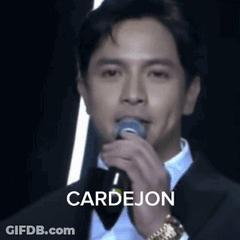 Man In Tuxedo Singing Into Microphone GIF