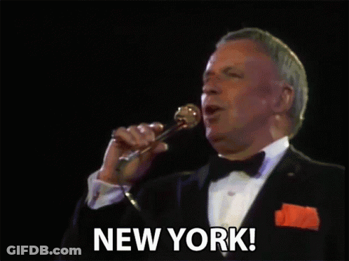 Man In Tuxedo Singing Into Microphone GIF