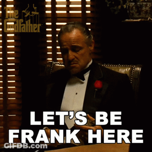 Man In Tuxedo Sitting At Desk Saying Let's Be Frank Here GIF